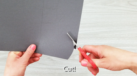 Scissors Cutting Black Paper