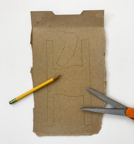 Cardboard with pencil and scissors