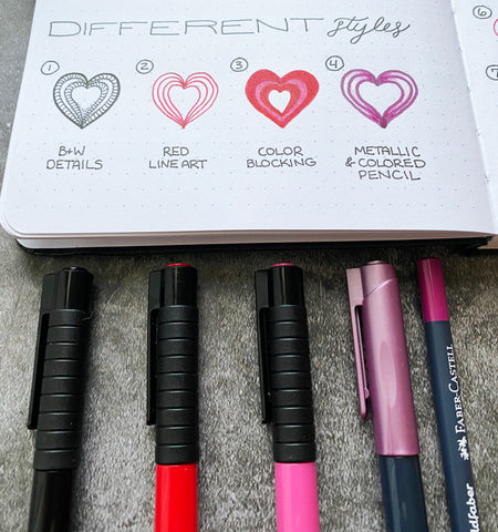 Bullet Journal with heart doodles, Pitt Artist Pens, a Metallic Marker, and a Goldfaber Color Pencil