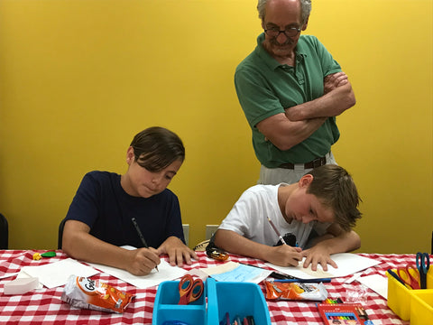 Two Children Coloring with Instructor