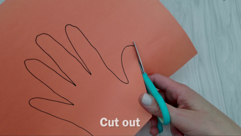 Scissor Cutting Traced Hand on Construction Paper