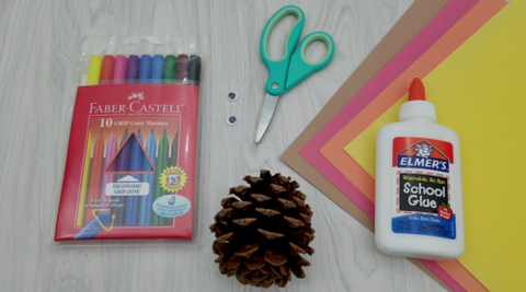Pine Cone Craft Supplies Including Glue, Pine Cone, Scissors, Washable markers, Construction Paper and Glue