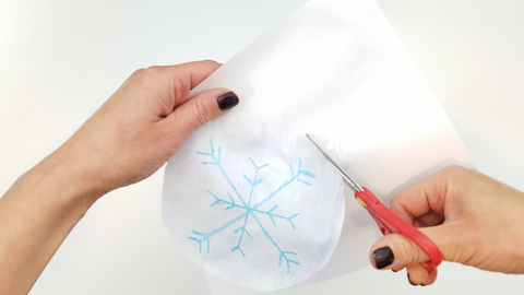 Cut shape from paper with snowflake