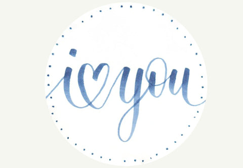 hand lettered i heart you on white circle tag