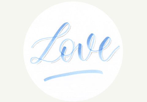 Hand lettered love on white tag