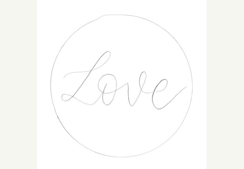 White tag with hand lettered love and circle