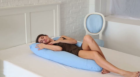 woman sleeping on blue colored pregnancy pillow perfect for pregnancy