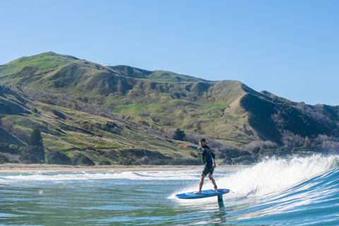 foil paddle boarding a wave