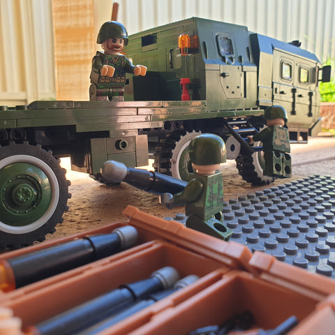 A Chinese soldier passing a warhead to Artillery Loader