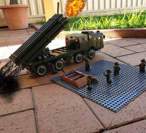 Soldiers watching as rockets are launched