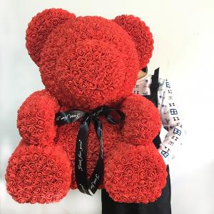 big teddy bear and flowers