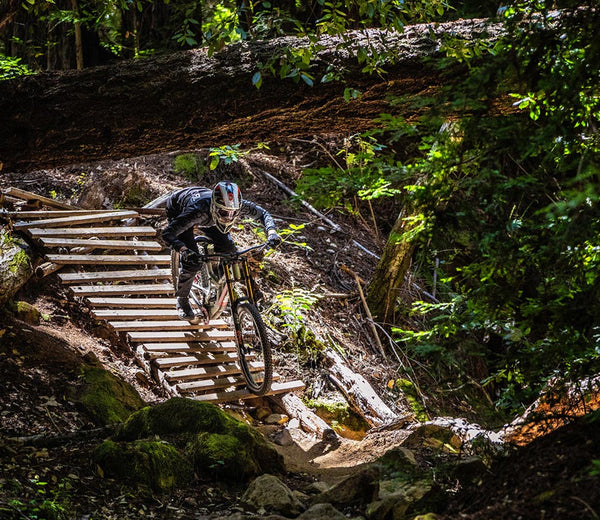 greg minnaar pro downhill rider on mountain bike park feature