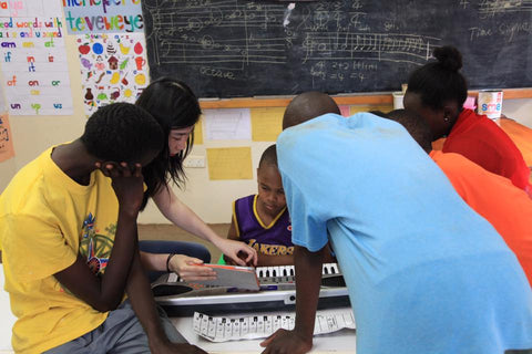 Yifan Shao teaching music and piano at Rehema home orphanage