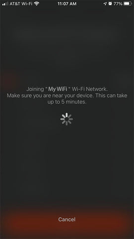 Screen with wait icon that displays while phone connects to device. Note this might take up to 5 minutes.
