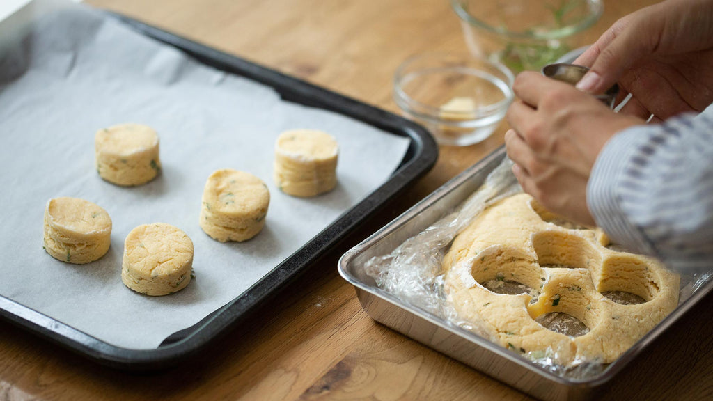 Cutting rosemary scones using cookie cutter