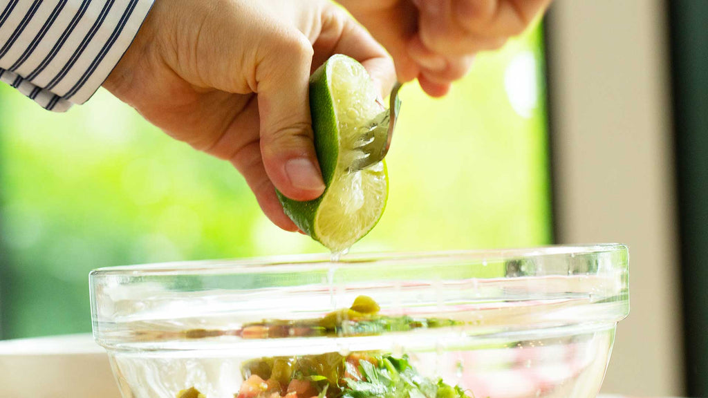 squeezing lime for pico de gallo