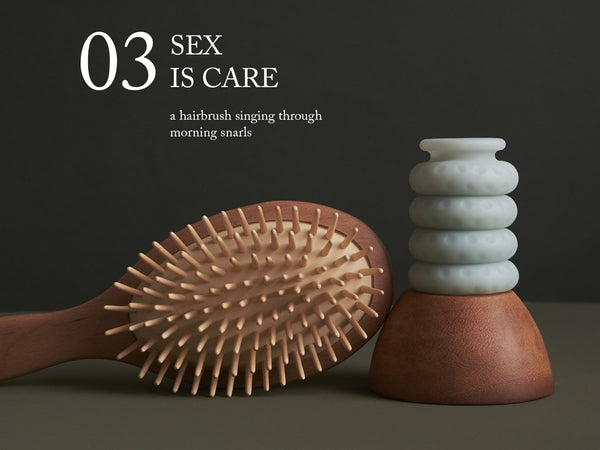 Image of a wooden hairbrush sitting next to an Ohnut. "03. Sex is care—a hairbrush singing through morning snarls."