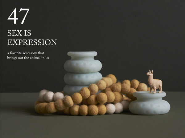 Image of a felt necklace wrapped around an Ohnut. A llama also perches majestically on a separate Ohnut ring. "47. Sex is expression—a favorite accessory that brings out the animal in us."