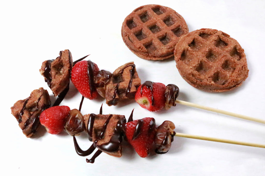 Skewers with waffles, strawberries, dates, and chocolate syrup drizzle
