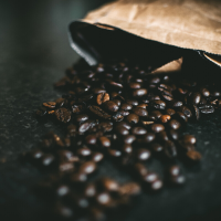 bag of coffee beans spilled on a table