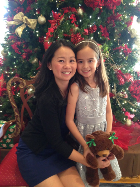 Dr. Wei and her daughter, Claire in front of a Christmas tree