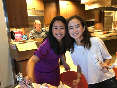 Mom and daughter building gingerbread houses