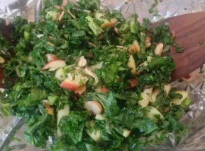 Kale salad with apples and almonds in a bowl