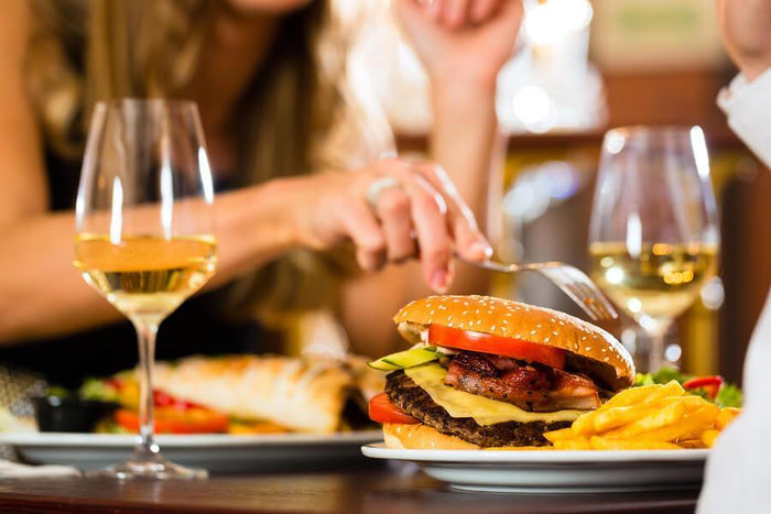 women eating a cheeseburger