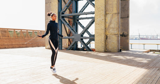 a lady is jumping rope outdoors