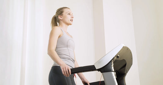 Sunny trainer running on treadmill