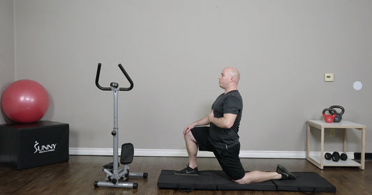 a man is working out on mat with steppers beside