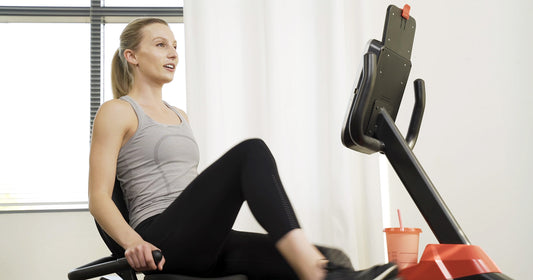 Sunny trainer riding recumbent bike