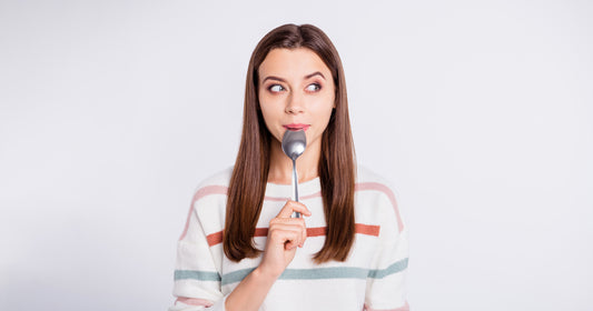 A hungry lady holding spoon into mouth dream of tasty meal