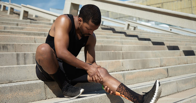 a man is touching his leg mucle after workout