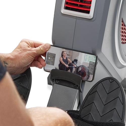 DEVICE & TABLET HOLDER | Follow along to your favorite Sunny Health & Fitness training videos on your tablet or mobile device.