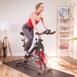 woman exercising on indoor cycle