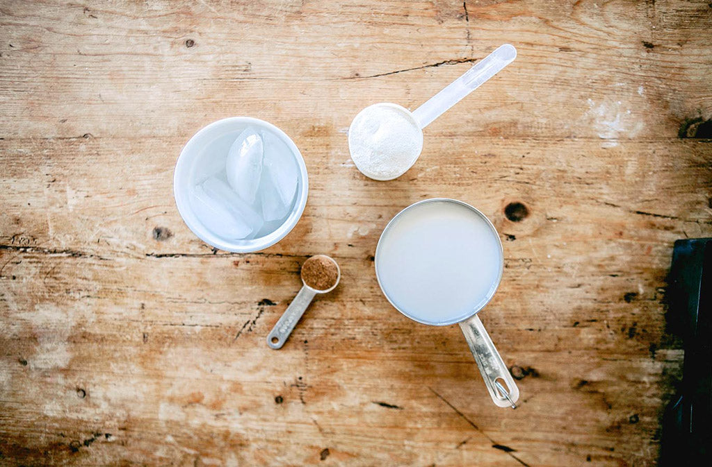 low carb protein shake ingredients displayed on a wood surface