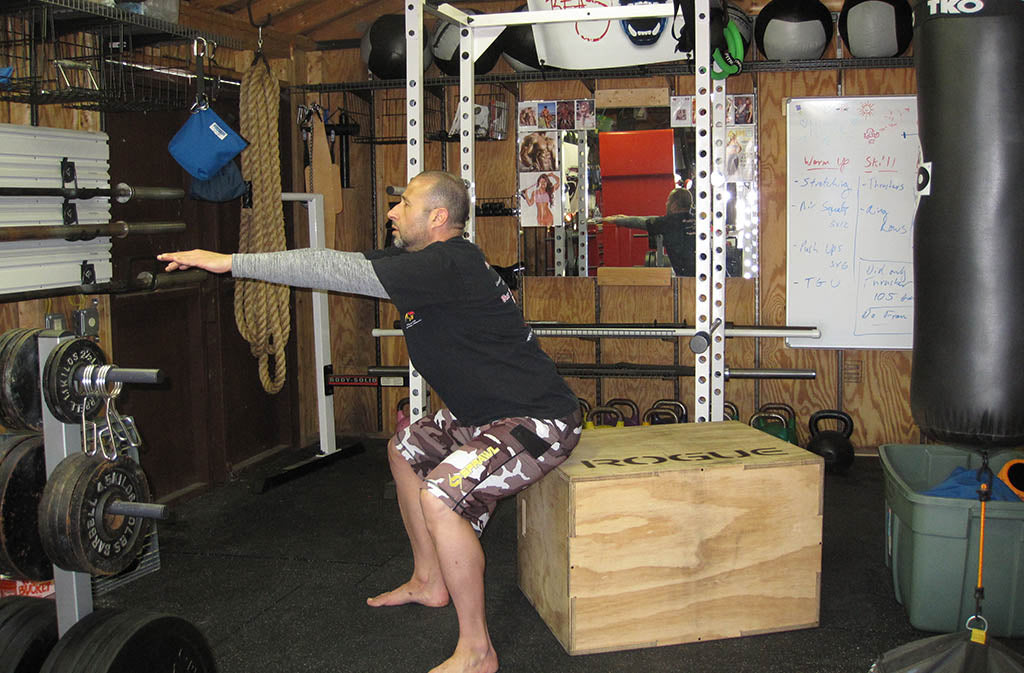 man doing a box squat