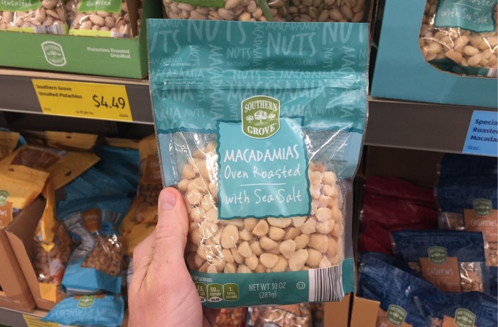 man's hand holding a bag of macadamia nuts