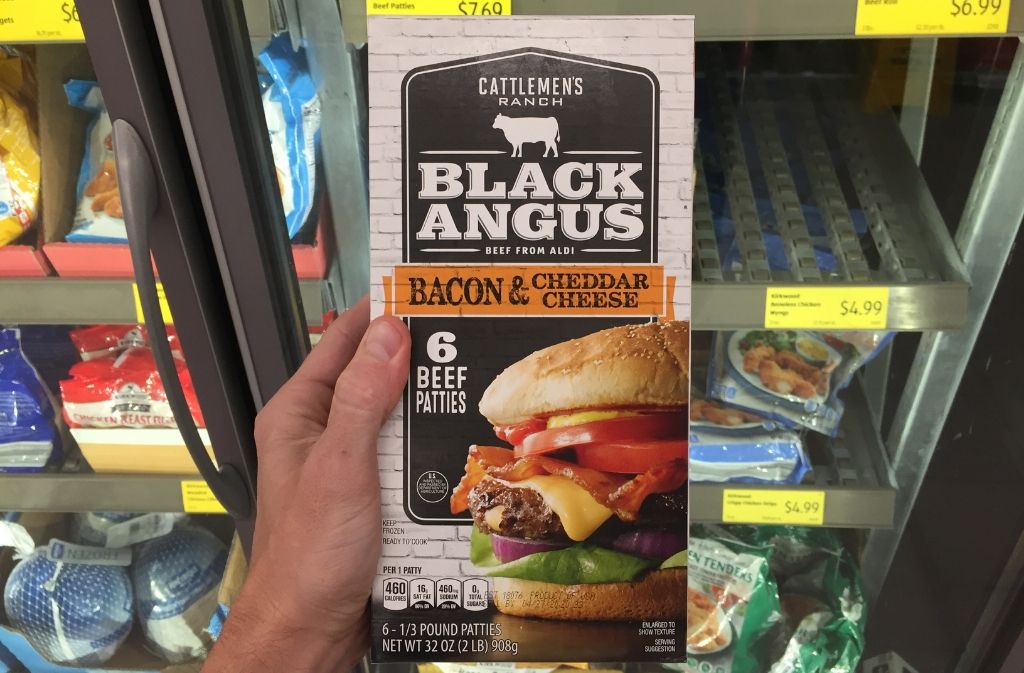 hand holding a package black angus burgers