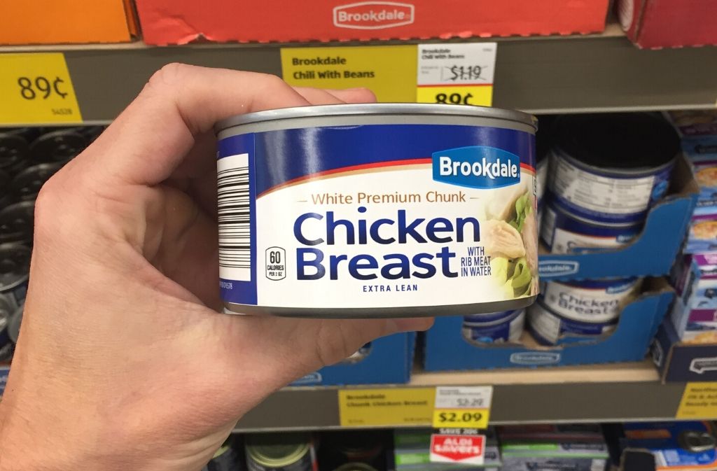 hand holding a can of chicken breast
