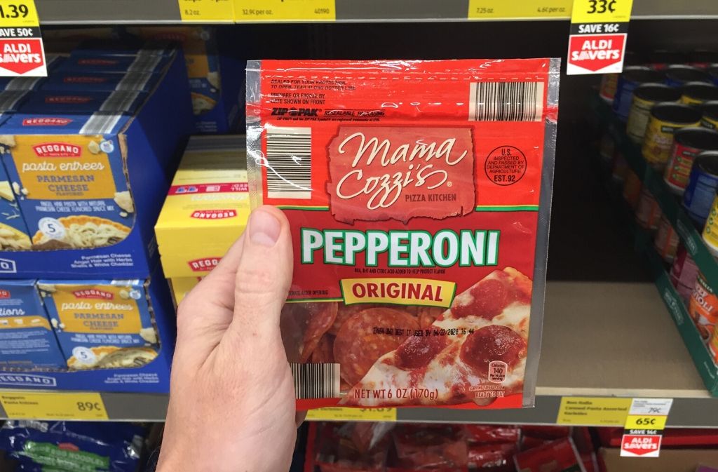hand holding a package of pepperonis