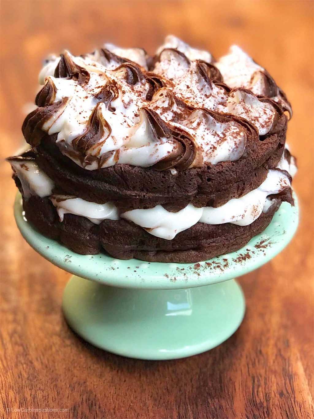 keto chocolate waffle cake on a teal cake display