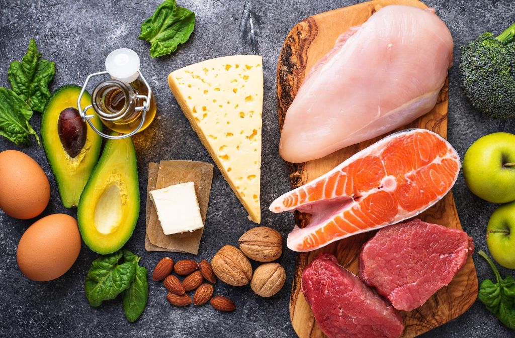 avocado, cheese, salmon, nuts, eggs, and other foods to include on a keto shopping list