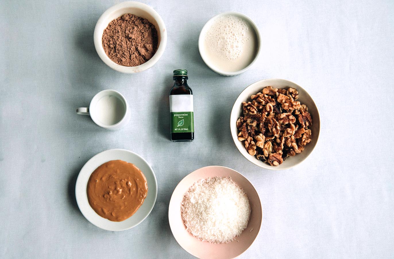 ingredients for mint chocolate keto energy balls displayed on a white surface