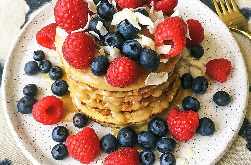 pancakes topped with raspberries and blueberries