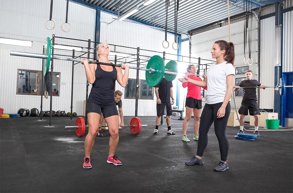 athletic woman in position for a shoulder press