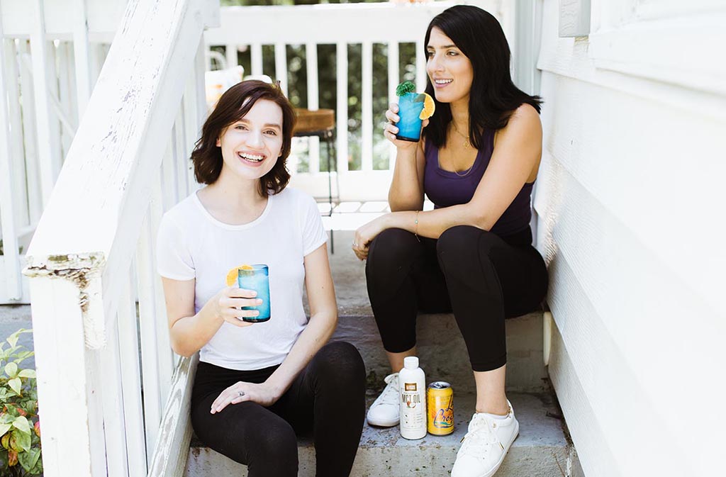 two women laughing drinking keto coconut creamsicle italian sodas