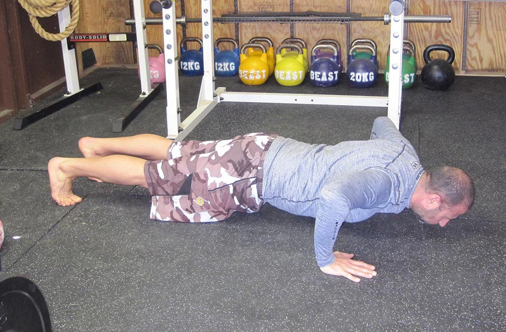 man at the bottom of a push up