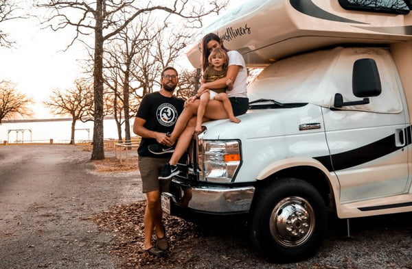 Mom, Dad, and Toddler with the RV.